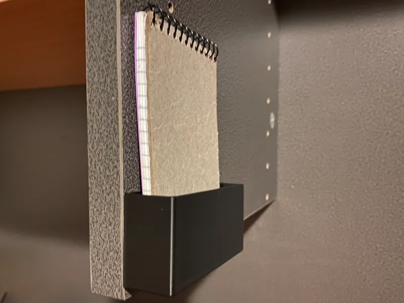 self hook mounted notebook holder