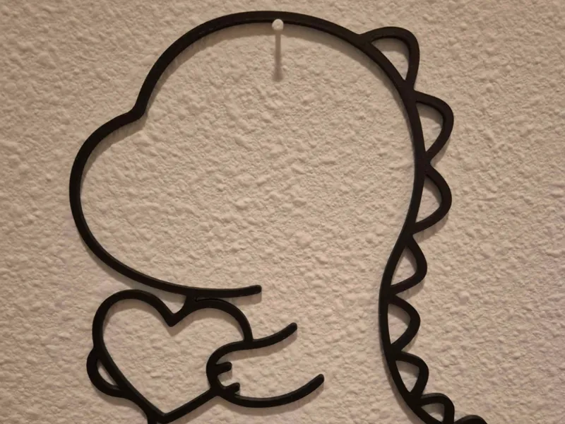 Wall art of a cute Dino holding a heart