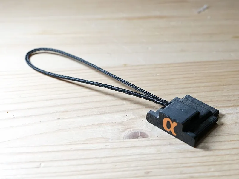 Sony hot shoe cover with safety cord