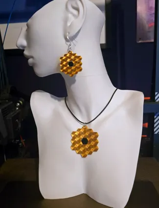 JWST Earrings and Pendant on fabric.