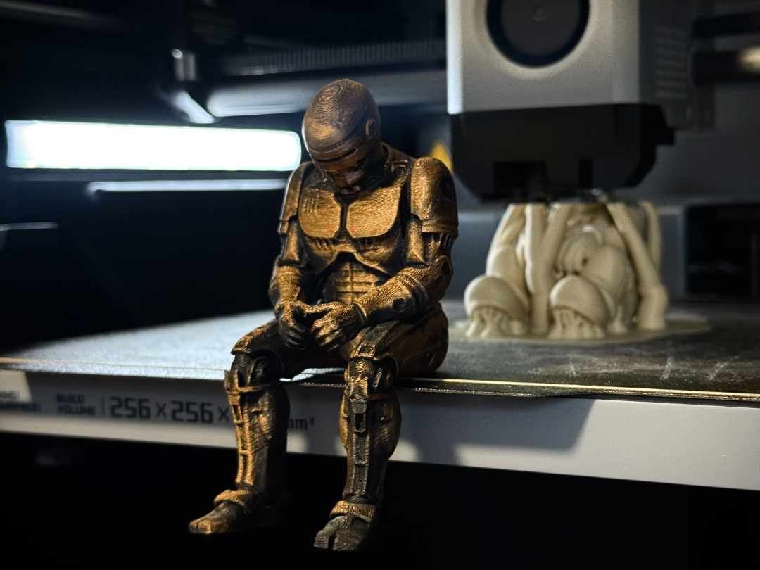 Sad RoboCop figurine sitting on a ledge!