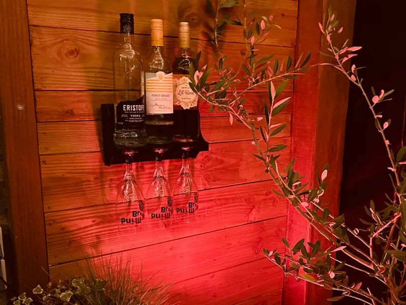 Beverage bottle shelf with glass hanging system.