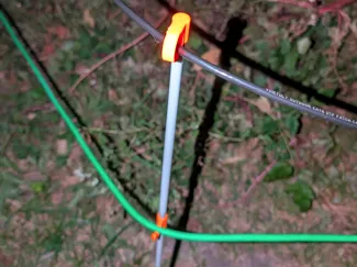 Yard stake cable guide and hook.