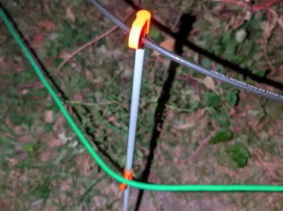 Yard stake cable guide and hook.