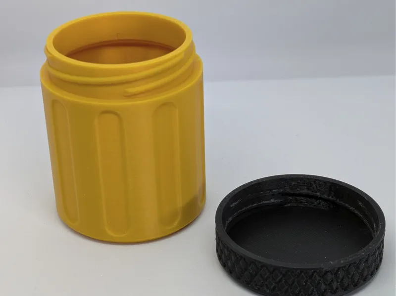 Small screw top container with knurled lid.