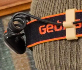 Pen and cable holders for headlamp