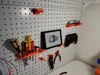 Tool holder, utilizing two hooks and a matching backing plate. Designed for screwdrivers and similar tools