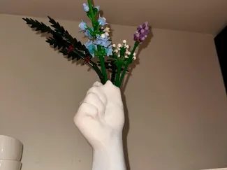 Hand holding flowers vase