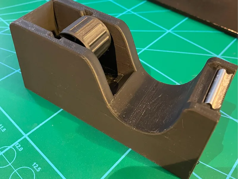 Tape dispenser with hole for knife