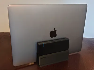 Vertical stand for a laptop and external storage 