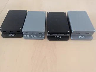 Stackable coin cell storage boxes