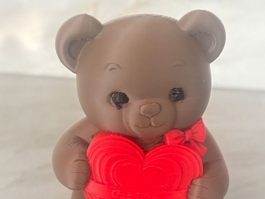 Cute bear holding a heart