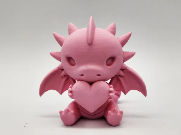 Petit dragon assis avec un cœur