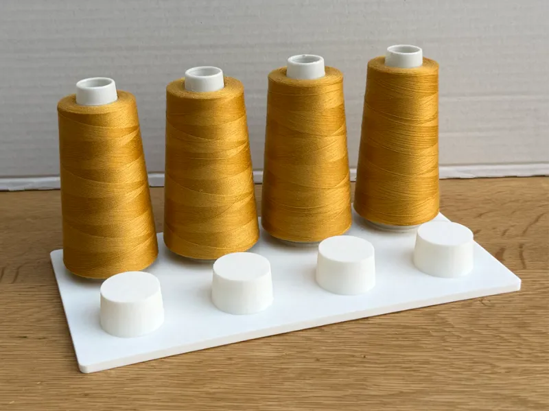 Plate holder for sewing lock thread spools