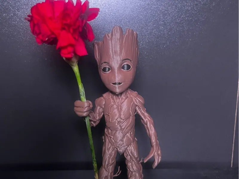 baby groot holder a flower