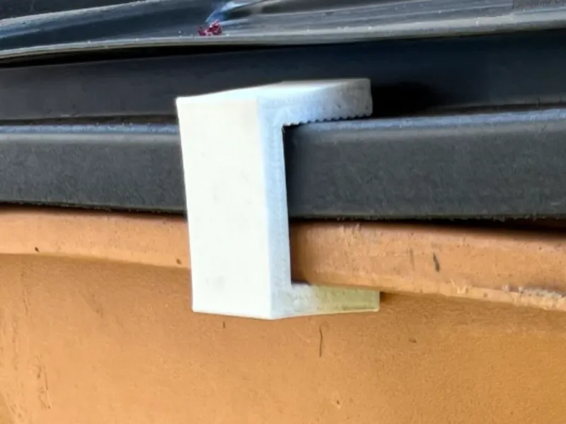 Trash bin clip for to keep raccoons out of garbage