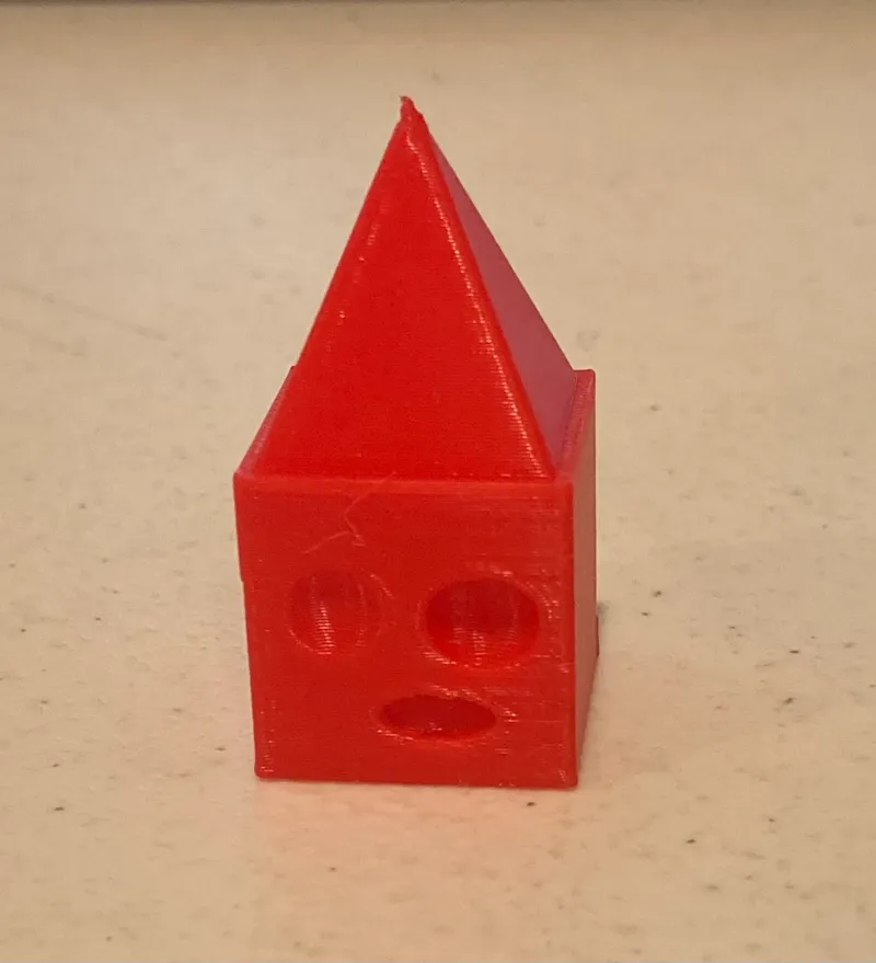 Cube with a pyramid on its head looking confused
