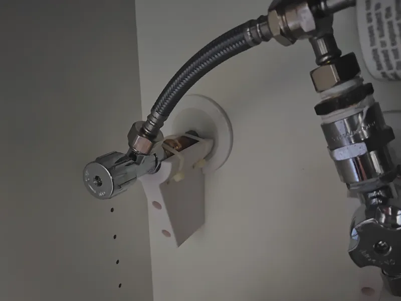 Plumbing Tap support under sink.