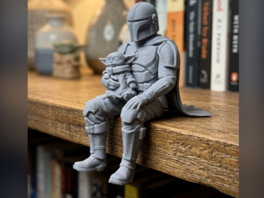 Madalorian with Grogu sitting on a ledge Figurine!