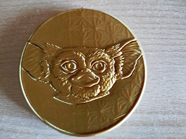 Pièce dorée à double face Gizmo