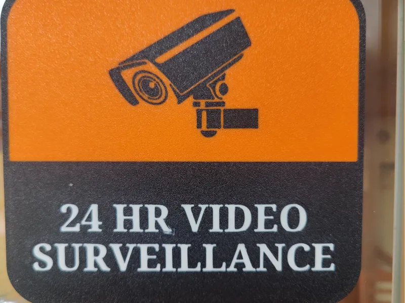 24 HR surveillance sign