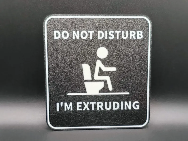Bathroom sign "I'm extruding" 