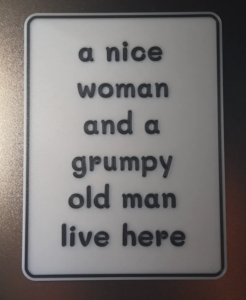 sign : a nice woman and a grumpy old man live here
