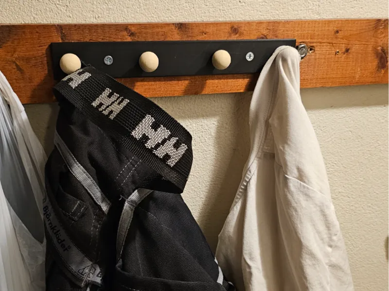 Wall mounted hanger with room for 4 "hooks" 