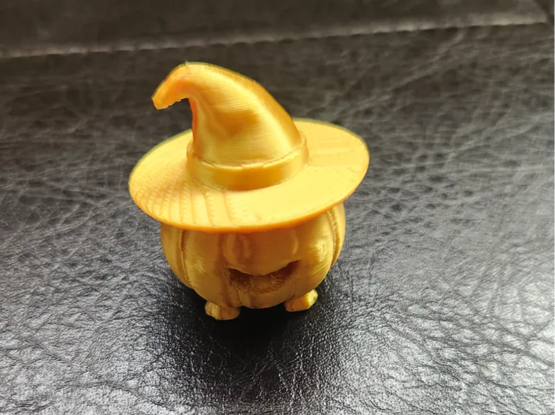 Cute pumpkin wearing a witches hat