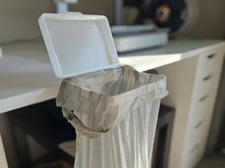 DeskBag: desk-mounted trash bag holder