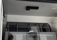 AMS lid lock with increased clearance in the guide
