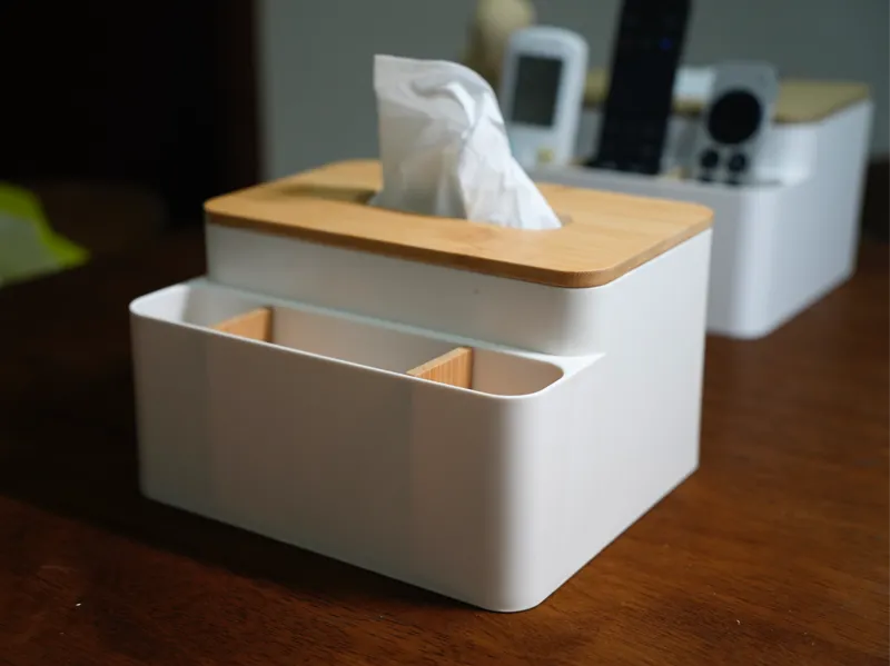 A desktop tissue box with a slot for remotes