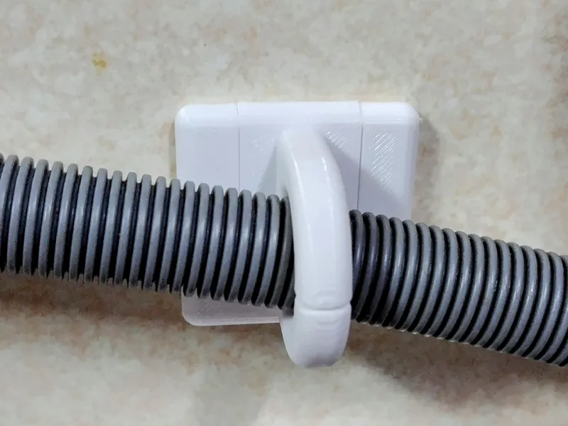 Dishwasher drain hose wall hook