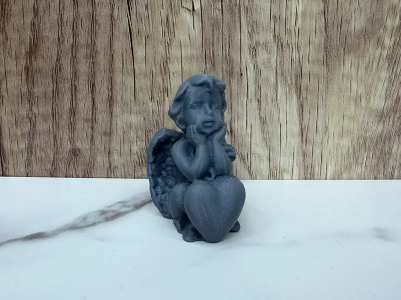 sitting angel with a heart