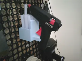 Glue gun holder for board with horizonal push-fit