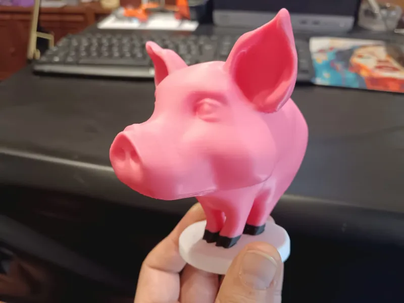 Cartoon-Style Pig Figurine on Pedestal