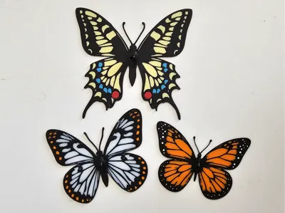 Butterflies glued on metal wire with ground spike