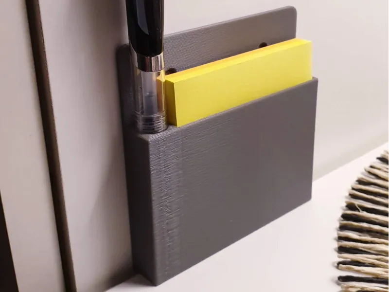 Stand on the wall for a pad with a pen