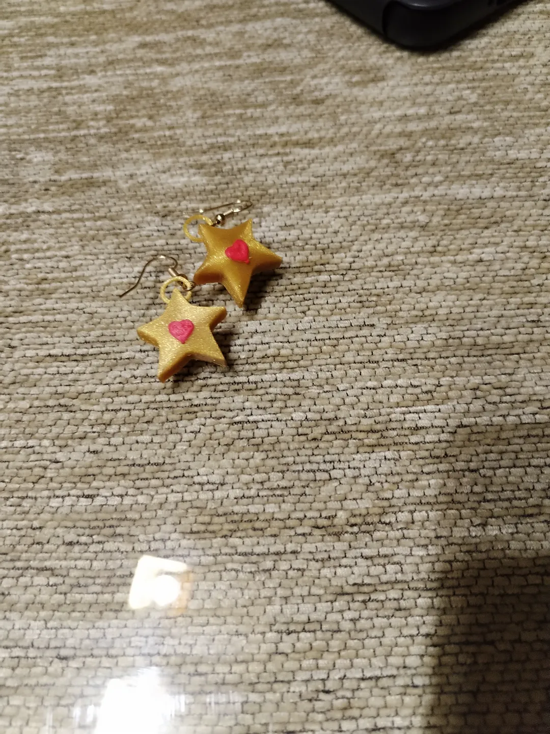 Golden star earrings with a heart view 4