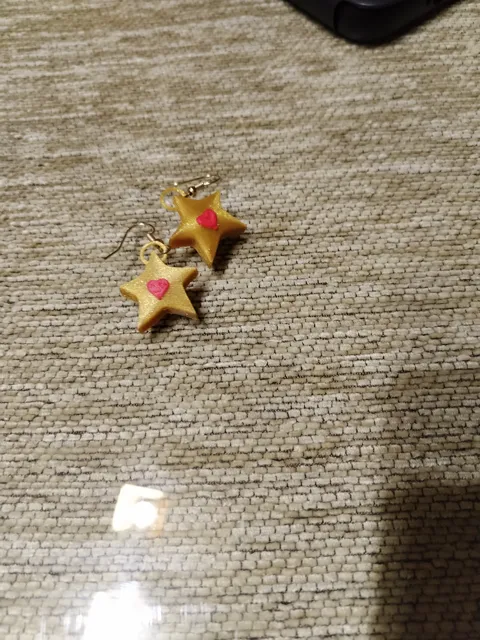 Golden star earrings with a heart view 4