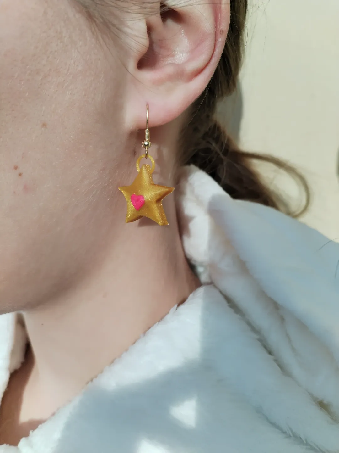 Golden star earrings with a heart view 2