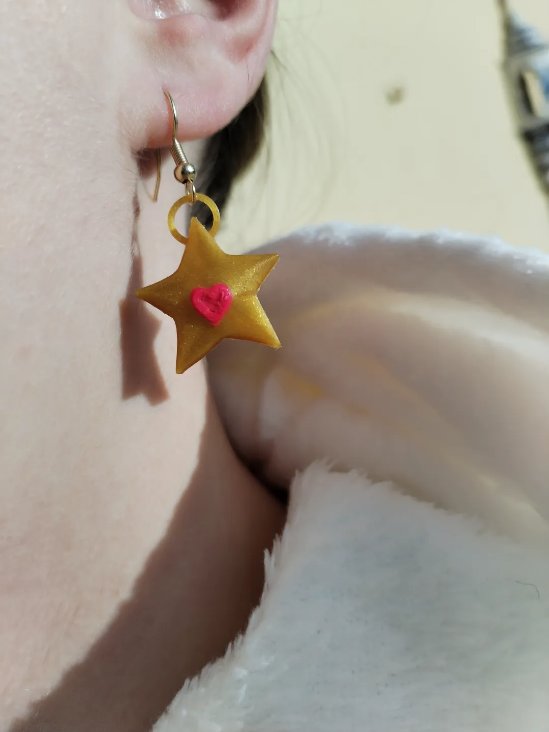 Golden star earrings with a heart view 3