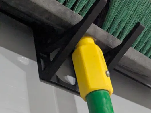 Slat wall hook for broom