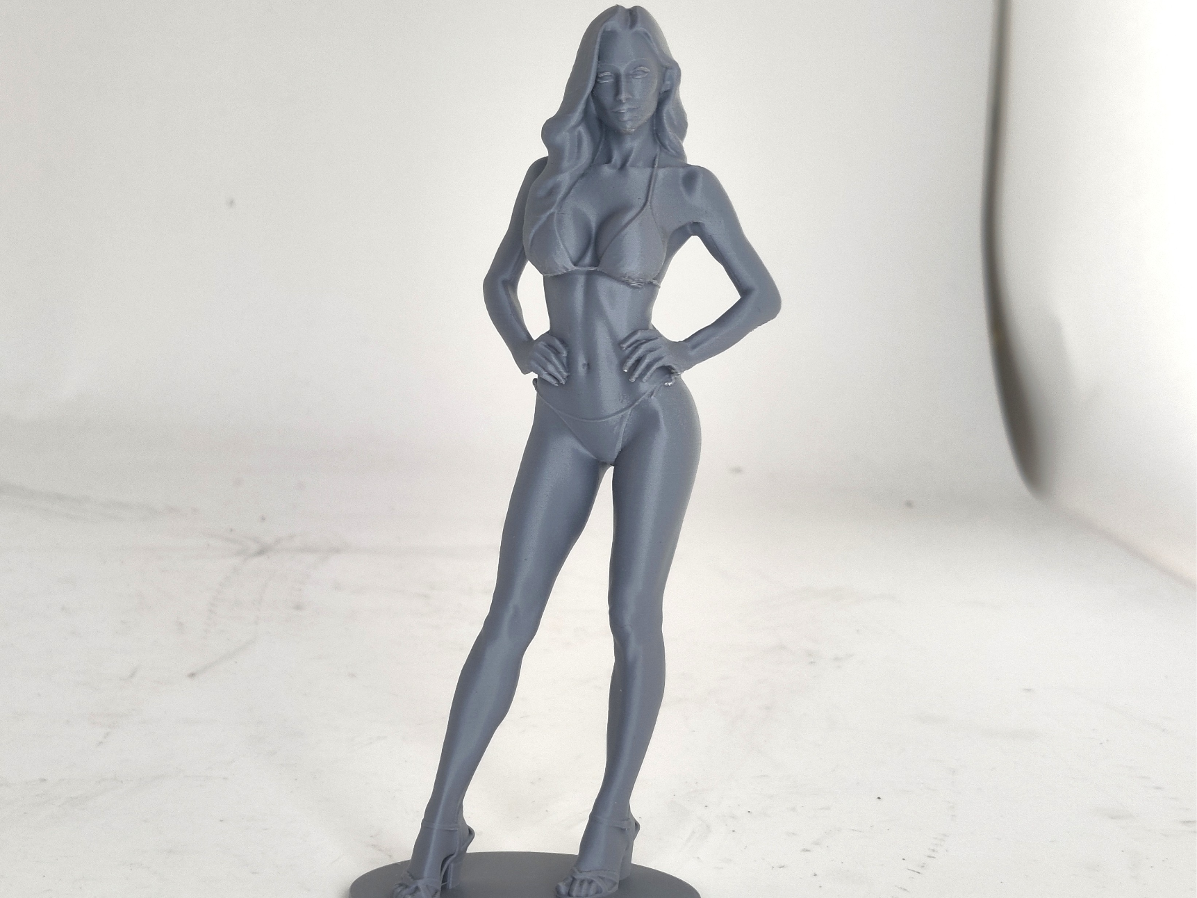 Sexy lady in bikini standing on base