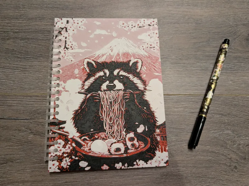 Notebook cover with cute raccoon design