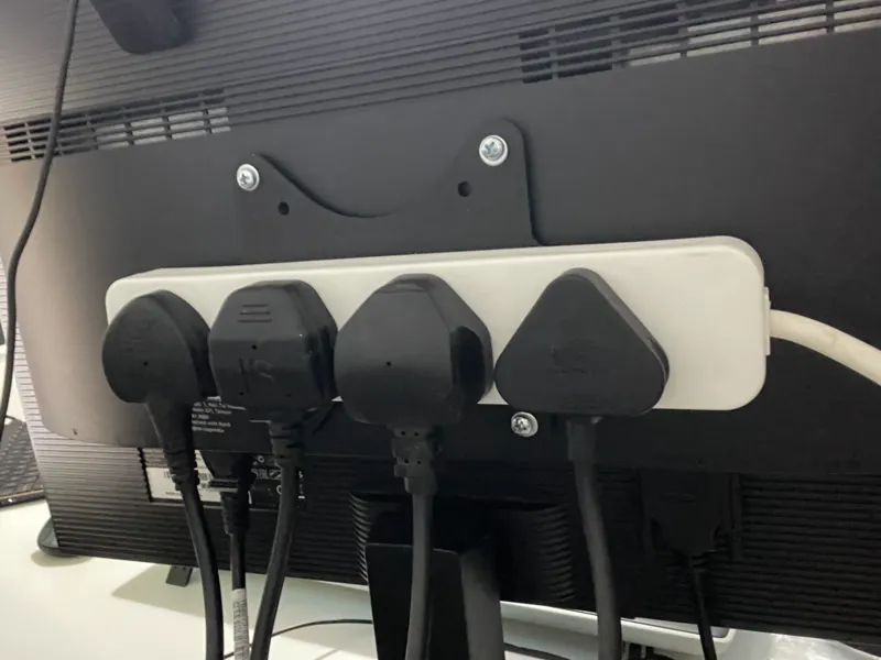 Adjustable extension socket holder for VESA mount
