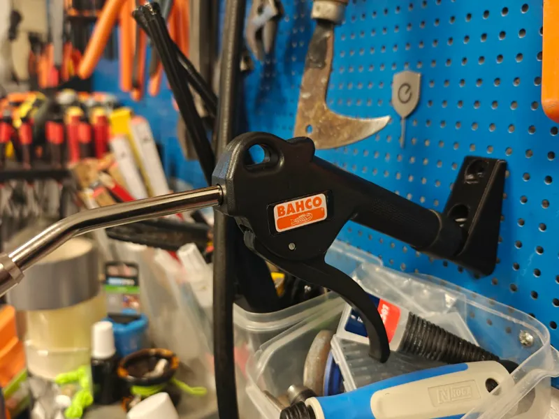 Universal air blow gun mount for peg board