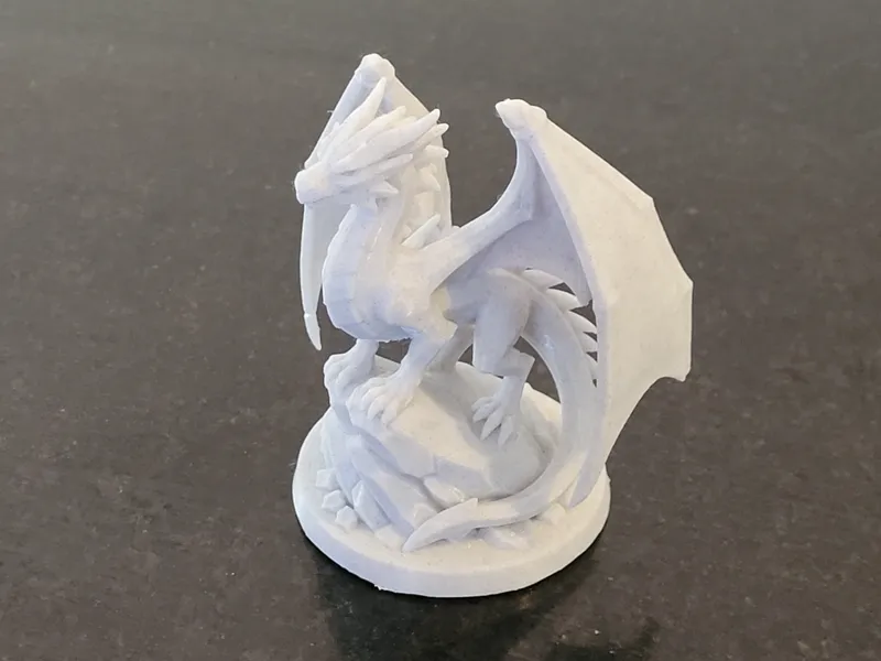 Dragon perched on rocks 100mm high