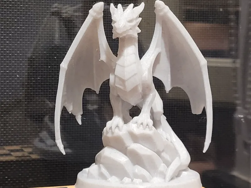 Dragon perched on rocks 100mm high