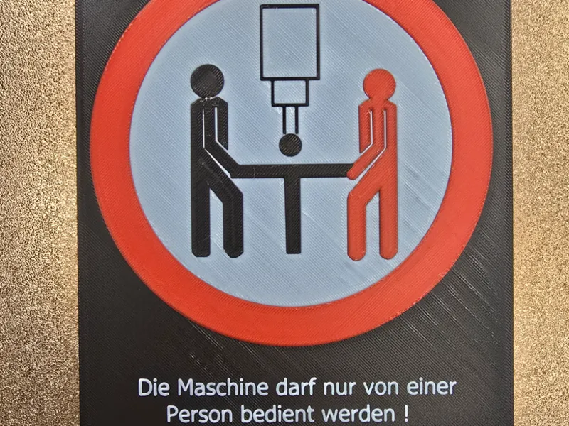 Warnschild Ein-Mann-Maschine
